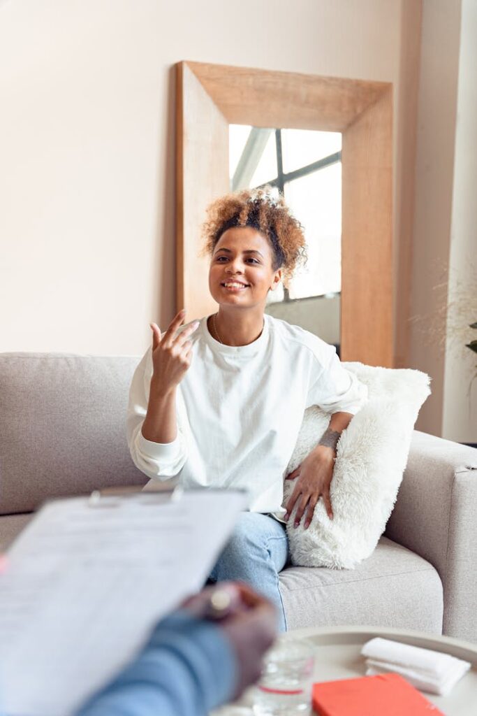 Crafting Captivating Headlines: Your awesome post title goes here Smiling woman in a therapy session on a comfortable sofa.